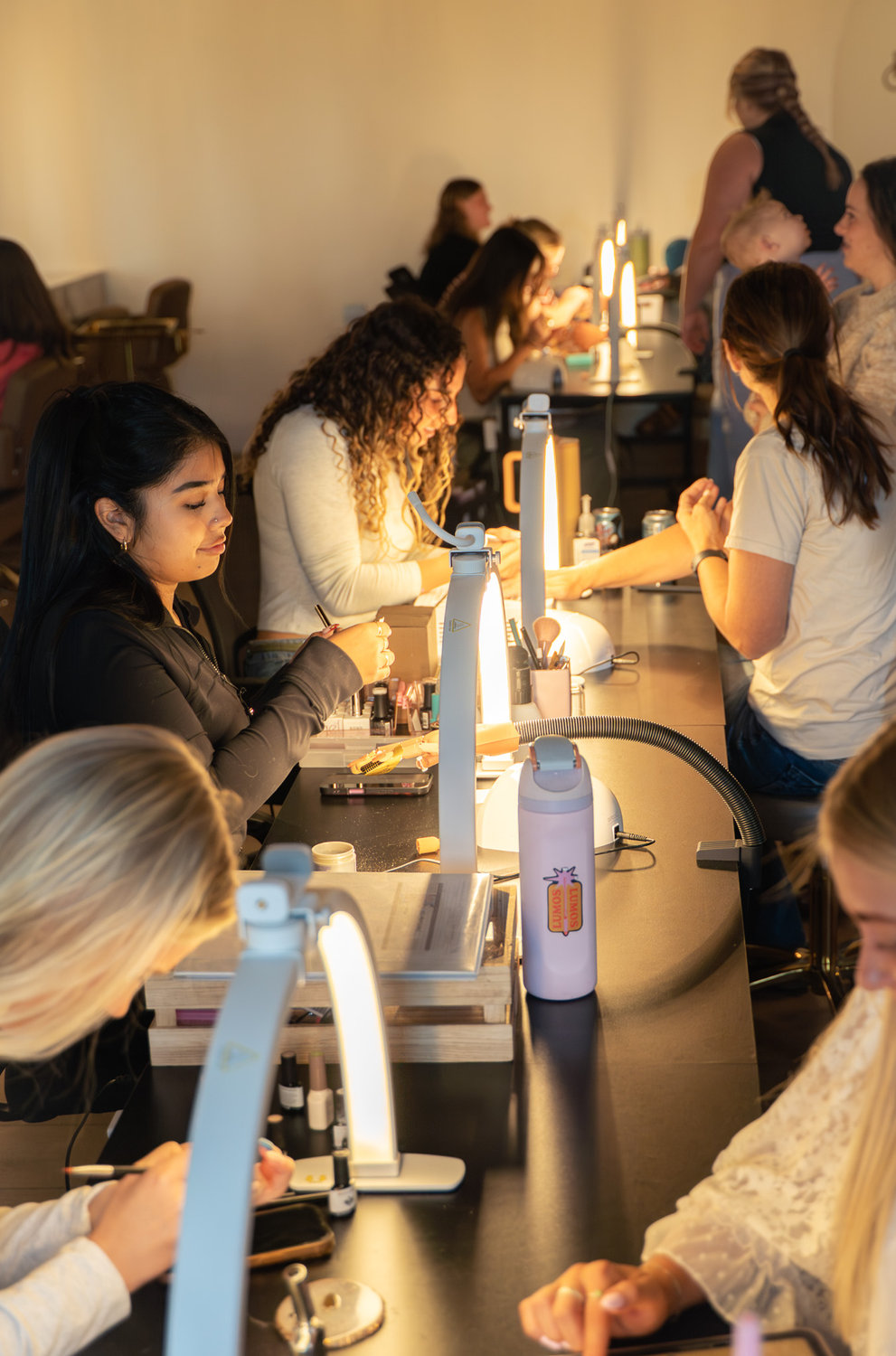 Students practicing nail techniques together