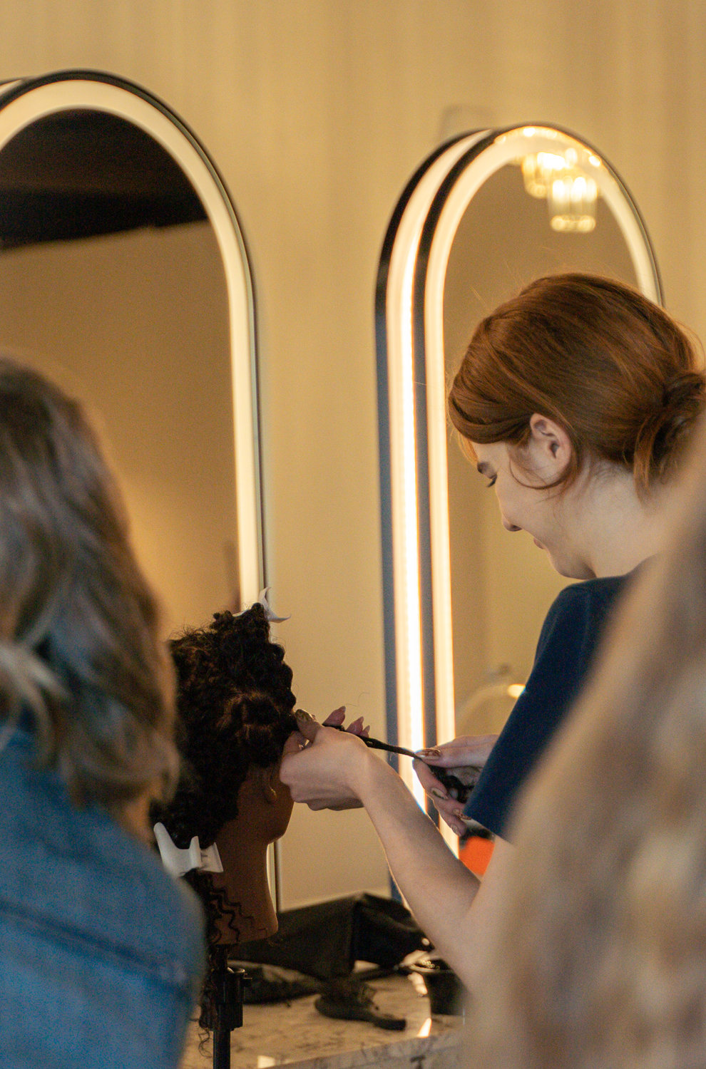 Hair styling instruction at Cambria Academy