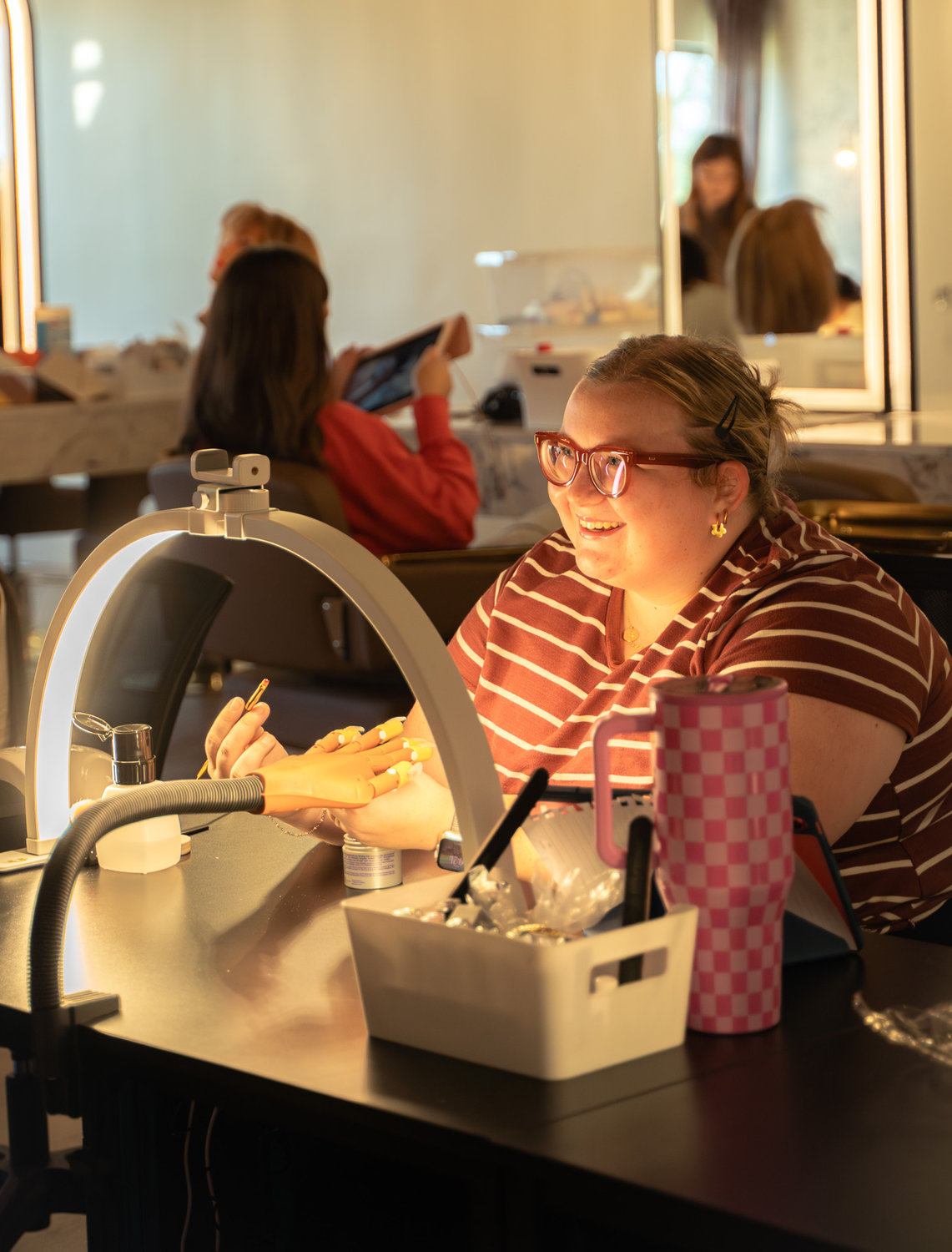 A Cambria Academy student developing precision during nail practice