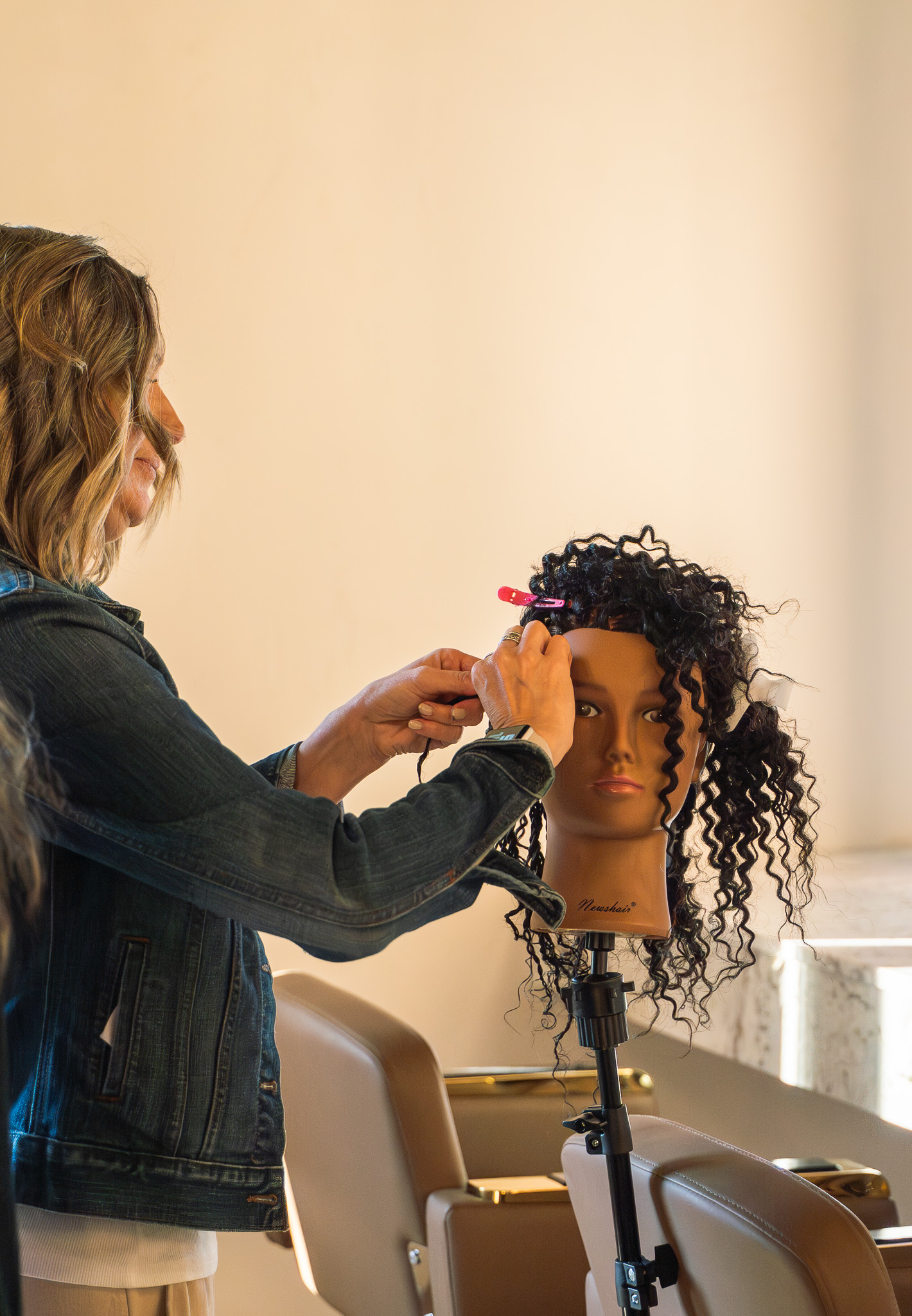Instructor teaching hair styling at Cambria Academy