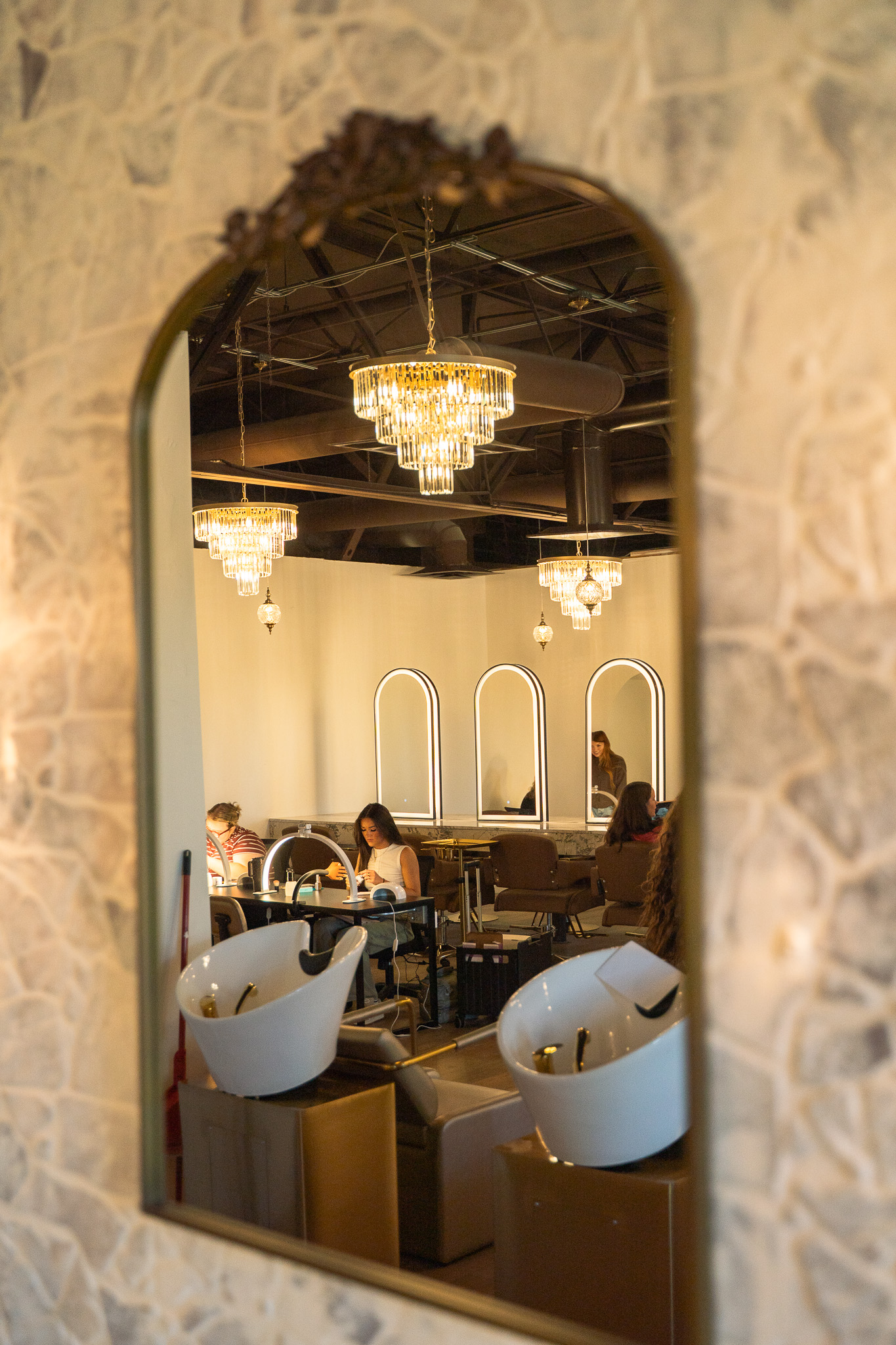 Students practicing in the Cambria Academy salon, reflected in an ornate mirror